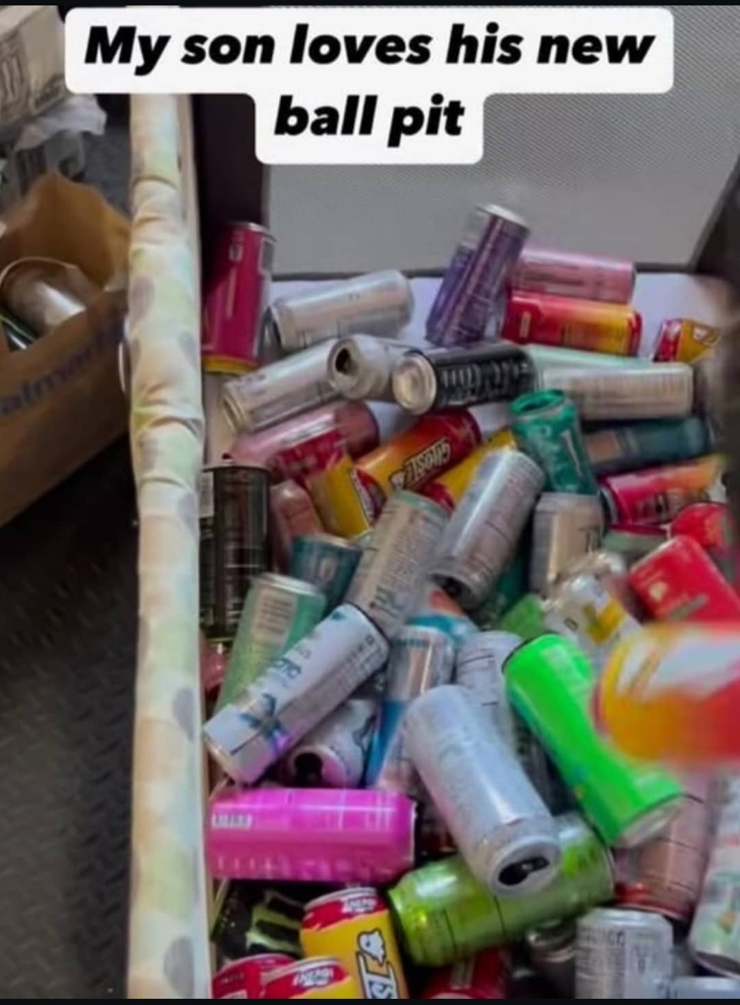 Playpen filled to the top with colorful empty aluminum energy drink cans funny meme.