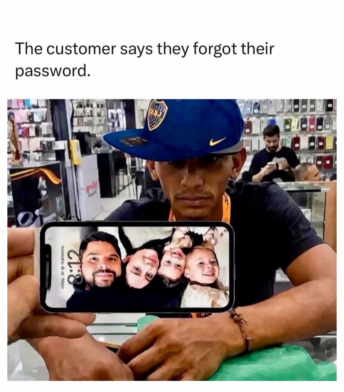 Phone store employee holding up an iPhone showing a family lock screen photo to a customer claiming forgotten password.