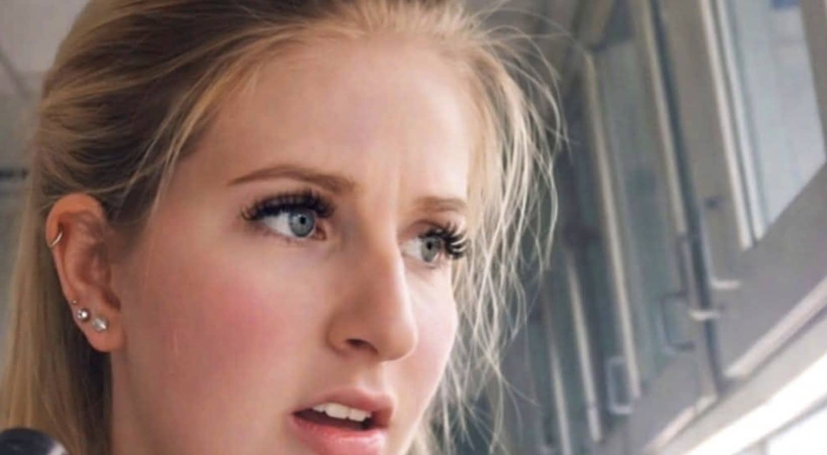 Side profile of a shocked blonde woman looking off-camera with a concerned facial expression.