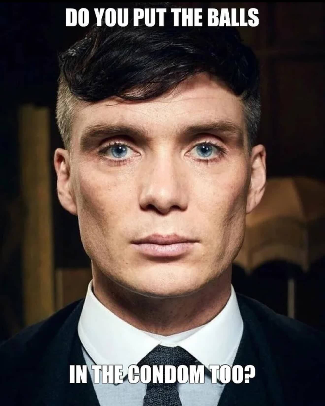 Close up portrait of actor Cillian Murphy with a funny text overlay inquiring about using condoms.
