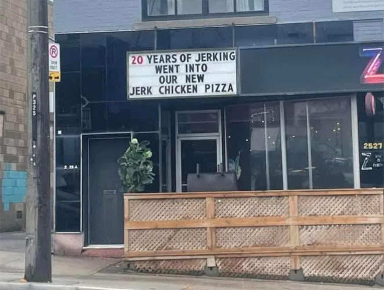 Funny restaurant sign mistake boasting twenty years of jerking for new jerk chicken pizza.