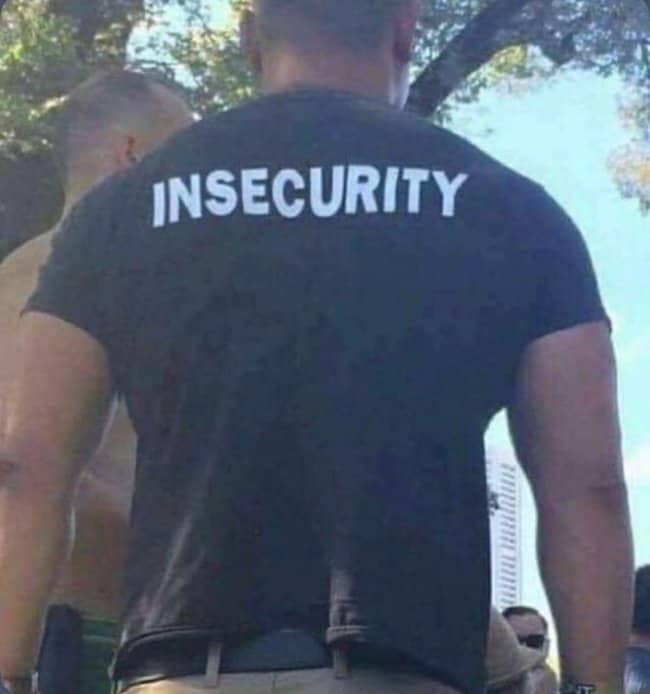 Muscular man wearing a black shirt printed with insecurity instead of security in funny outfits.