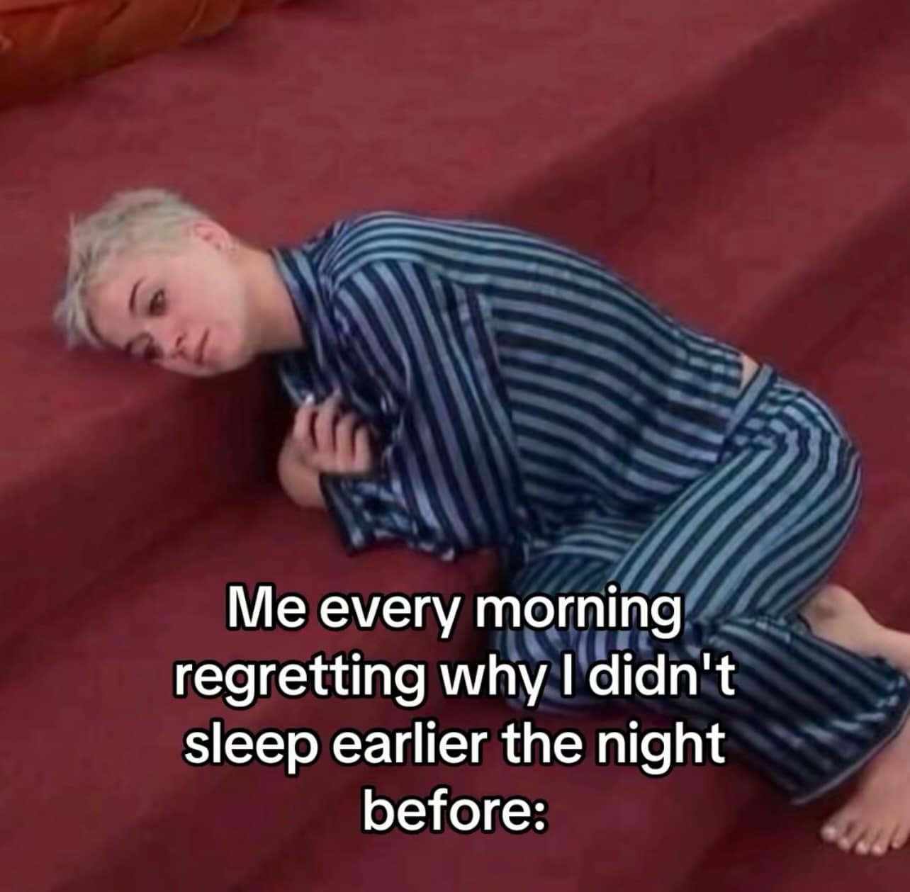 An incredibly relatable meme dump image shows pop singer Katy Perry slumped exhaustedly on carpeted stairs while wearing dark blue and white striped silk pajamas. Bold white overlay text at the bottom channels universal morning exhaustion, stating: "Me every morning regretting why I didn't sleep earlier the night before:".