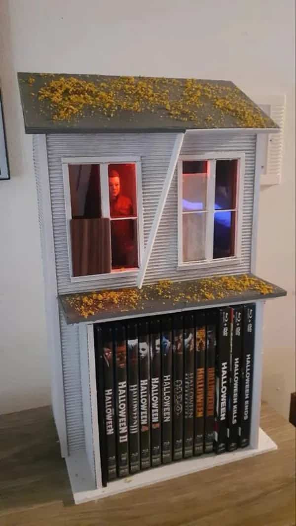 Custom Halloween horror movie shelf holding Blu-rays with Michael Myers standing in the window top.