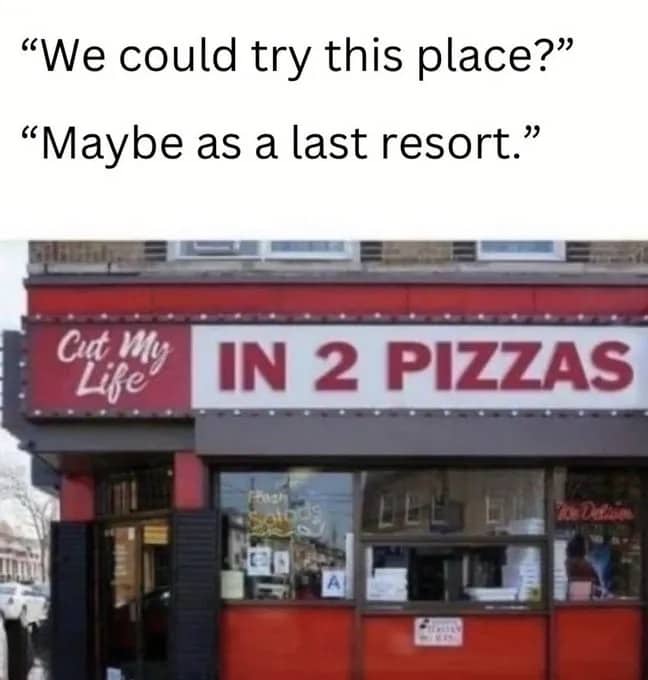 Storefront sign reading Cut My Life In 2 Pizzas referencing Papa Roach song lyrics.