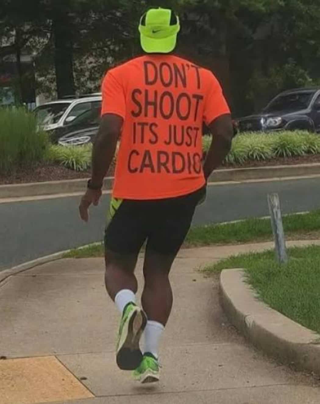 Funny outdoor fitness meme showing a jogger wearing a bright orange shirt that reads dont shoot.