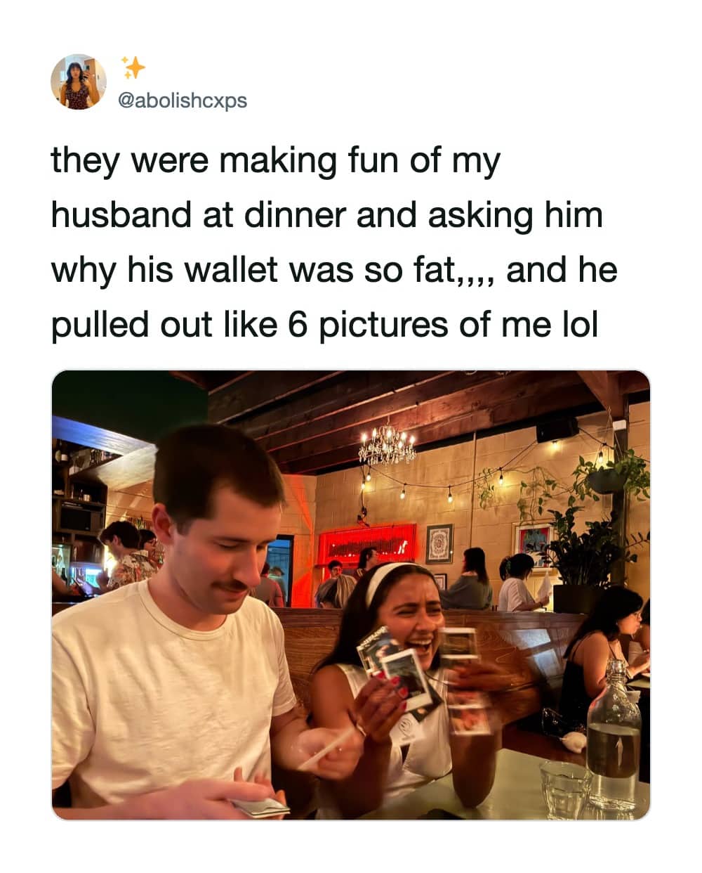 Man at a restaurant pulling out multiple Polaroid photos of his wife from a thick wallet.