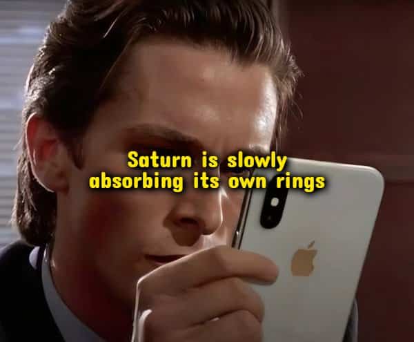 Patrick Bateman looking intently at a smartphone screen displaying space trivia random useless facts.