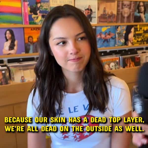 Olivia Rodrigo looking thoughtful in a music store for a dark shower thoughts meme.