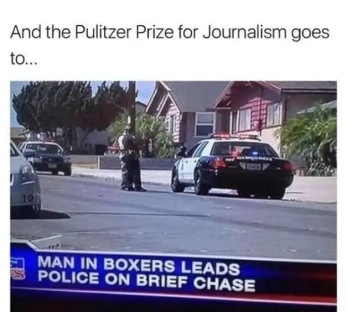 Policemen standing on a suburban street next to a cruiser during a brief chase.