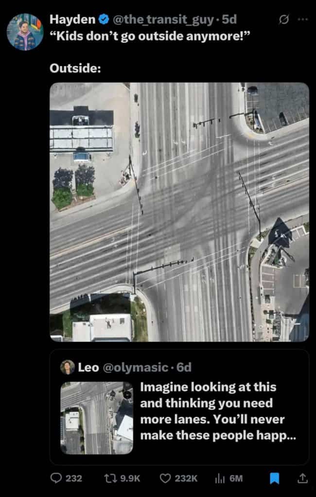 Massive multi-lane highway intersection aerial view depicting car-centric urban design infrastructure.