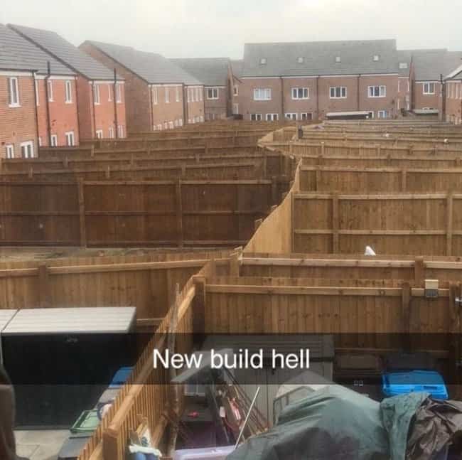 Maze of wooden privacy fences surrounding packed suburban backyard new build developments.