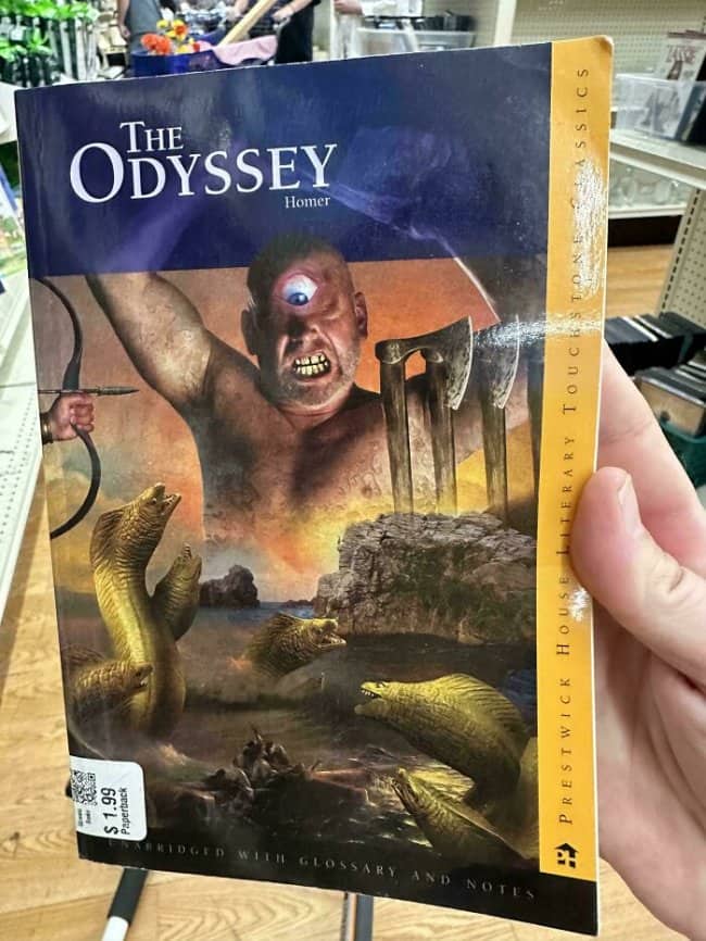 Paperback cover of The Odyssey showing a comically photoshopped cyclops holding sharp axes.