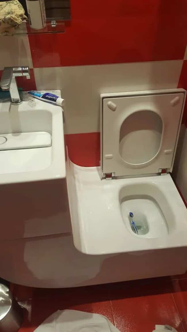 A toilet seat attached directly to a bathroom sink unit in an uncomfortably cramped design.