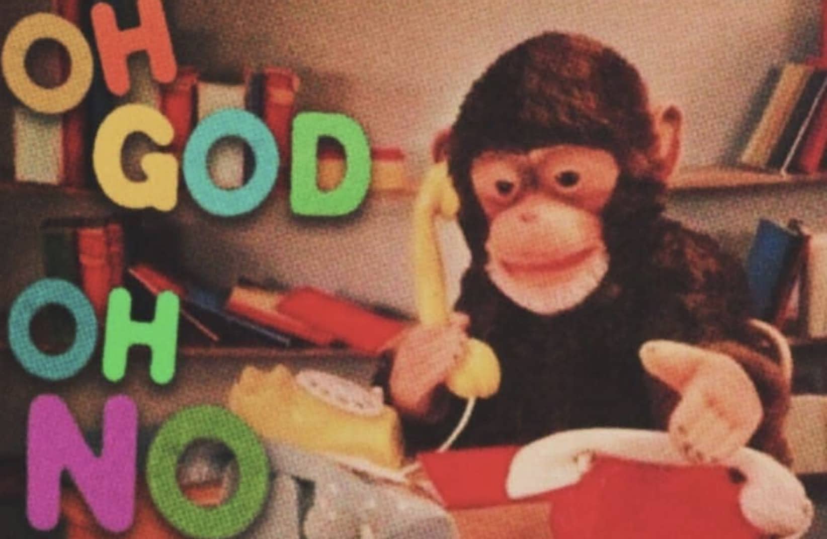 Chimpanzee talking on a yellow landline telephone next to colorful letters spelling Oh God Oh No meme.