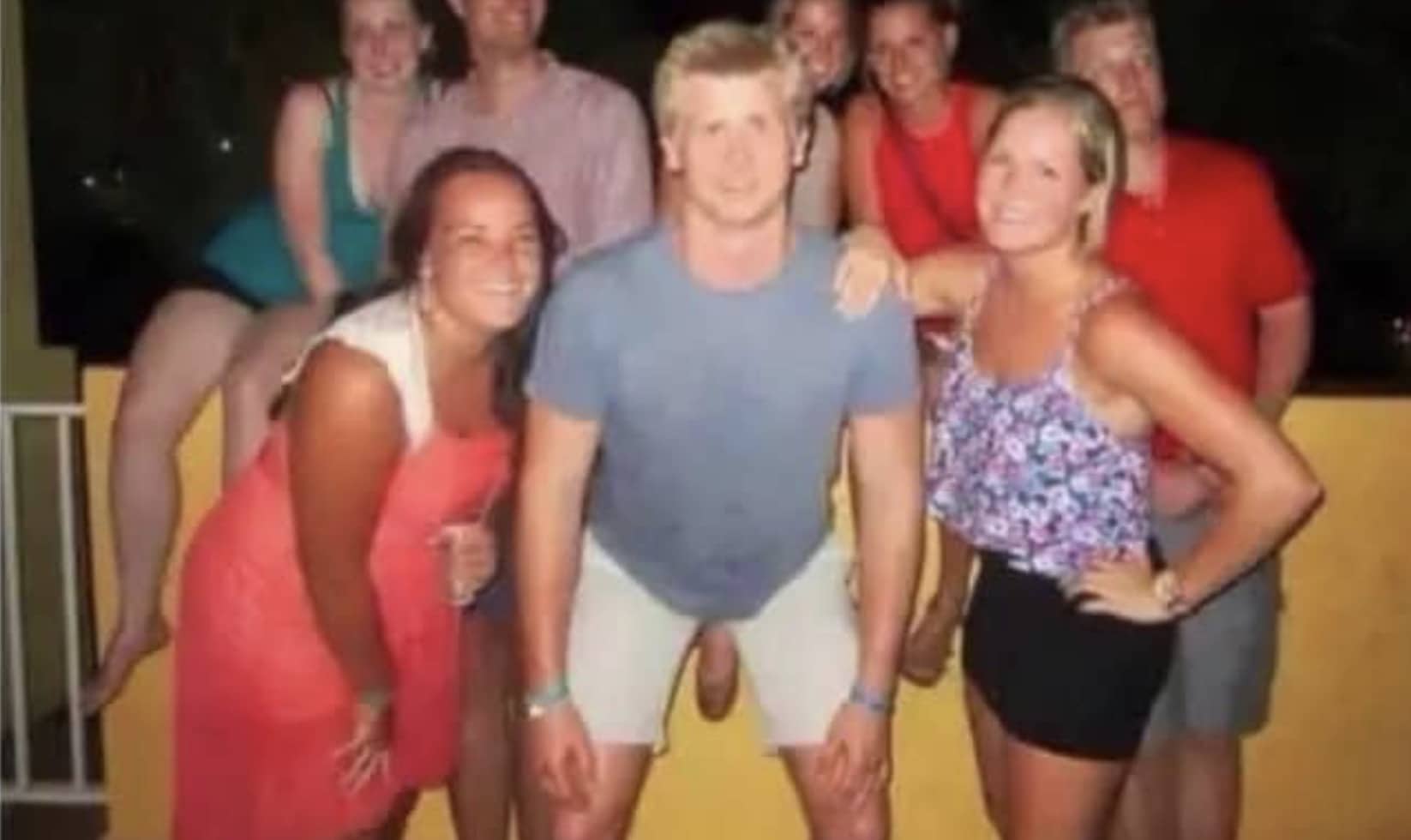 Optical illusion funny meme showing a man crouching next to a woman creating an awkward perspective.