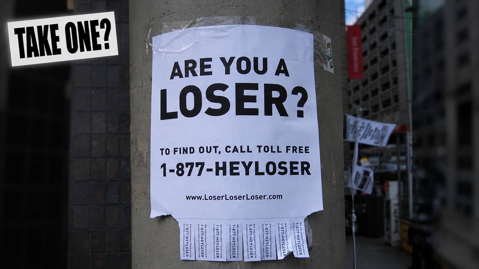 Street flyer taped to pole asking are you a loser with pull tabs