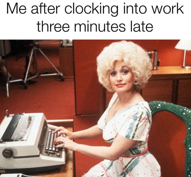 Dolly Parton as Doralee in 9 to 5 sitting at a vintage office typewriter, looking over her shoulder with a satisfied smirk, captioned about clocking into work three minutes late.