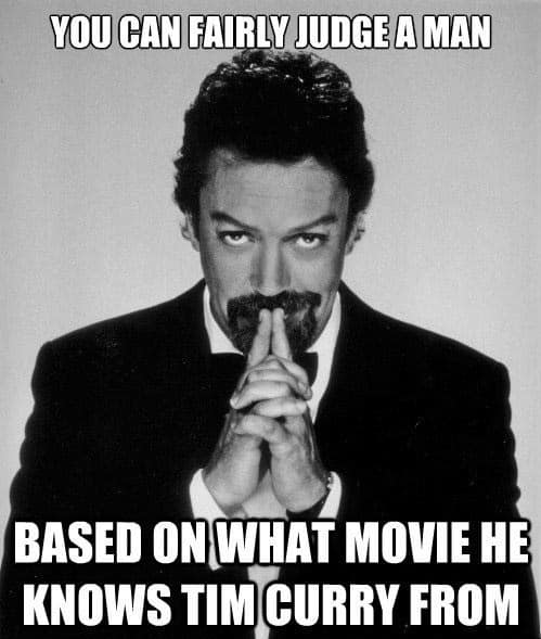 Black-and-white portrait of Tim Curry with steepled hands in a tuxedo, accompanied by text stating that you can fairly judge a person based on which of his film roles they recognize first.