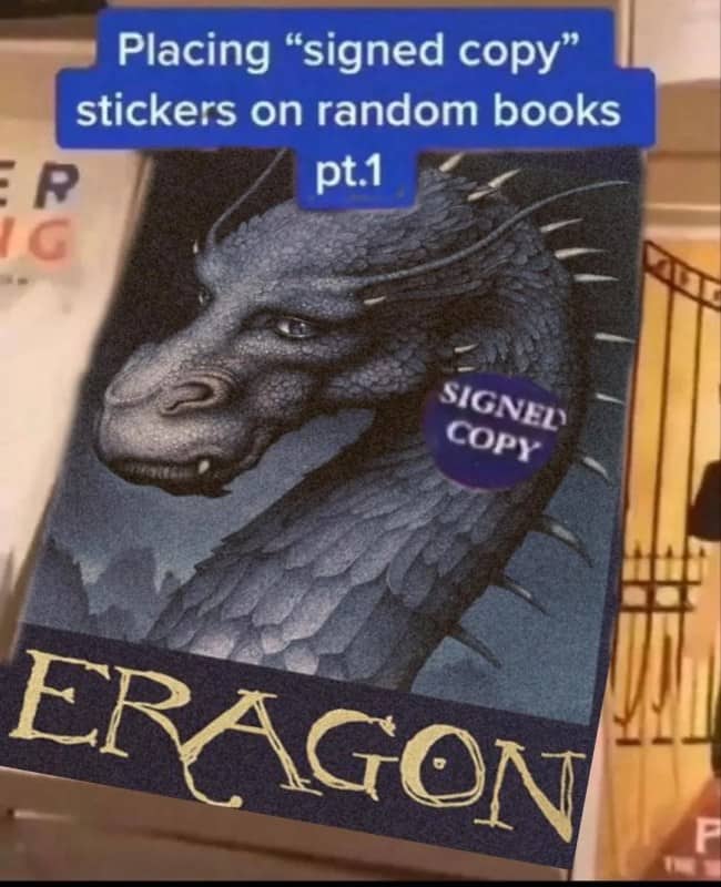 Eragon fantasy novel cover featuring a falsely placed signed copy sticker by a prankster.