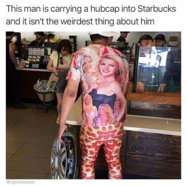 Photo of a man in Starbucks wearing a Britney Spears graphic shirt and pepperoni pizza leggings while holding a car hubcap.
