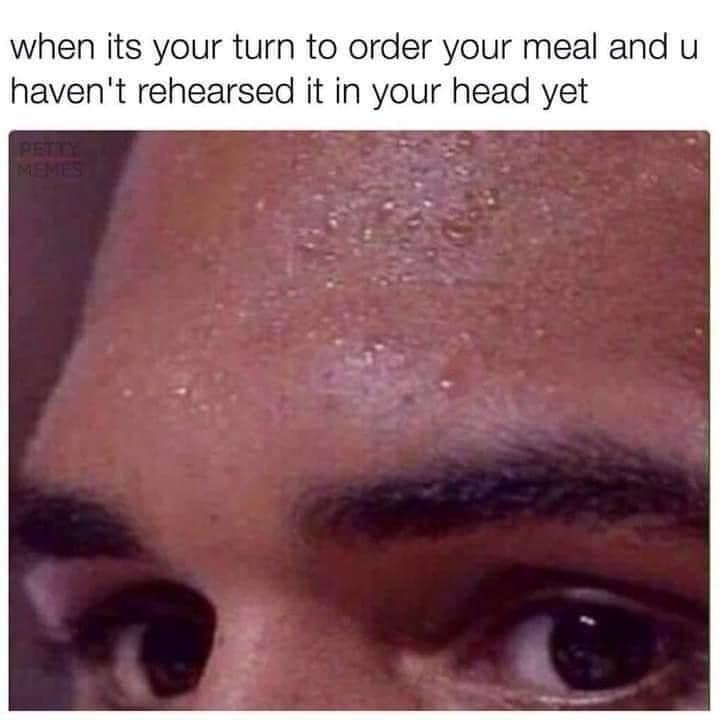 Extreme close-up of a person's sweaty forehead and anxious eyes, capturing the panic of ordering food at a restaurant counter without mental preparation.