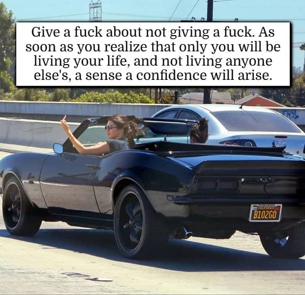 Convertible car driver giving middle finger with confidence hacks text on independence.