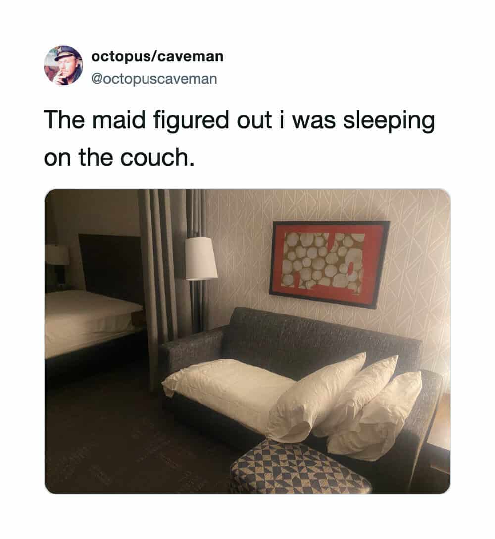 Funny hotel room photo showing a sofa neatly made up with sheets.