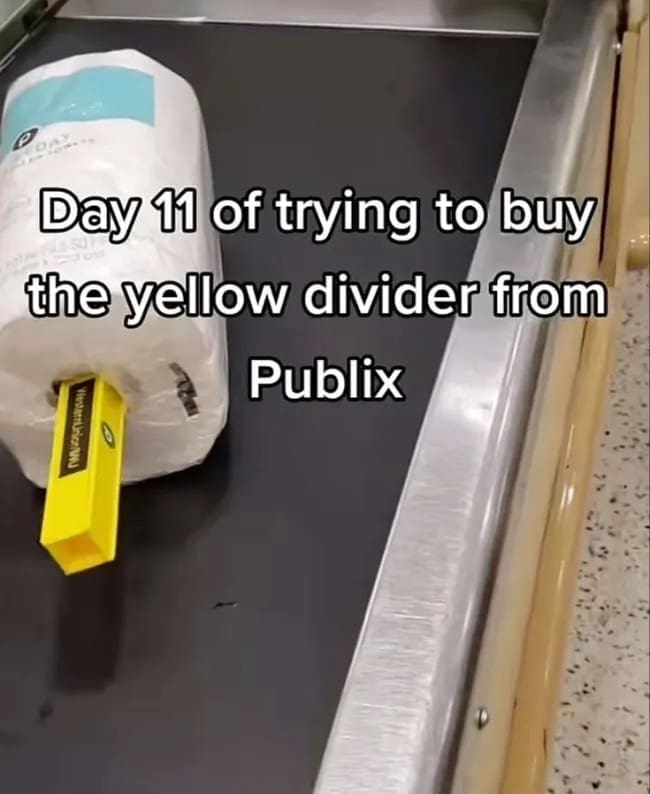 Paper towel roll on grocery checkout conveyor belt stuck on yellow divider funny memes.