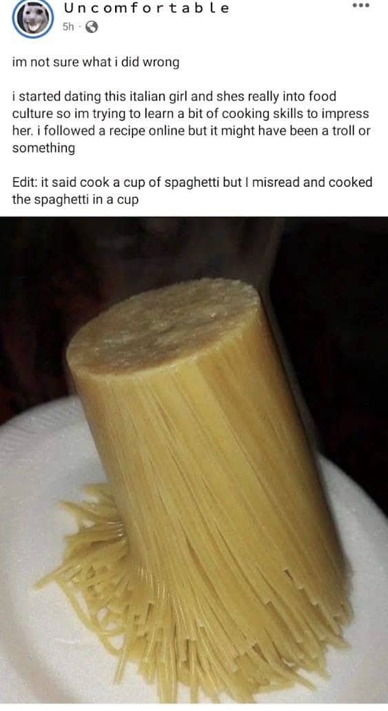 Cylindrical block of cooked spaghetti noodles standing upright on a plate, funny memes.