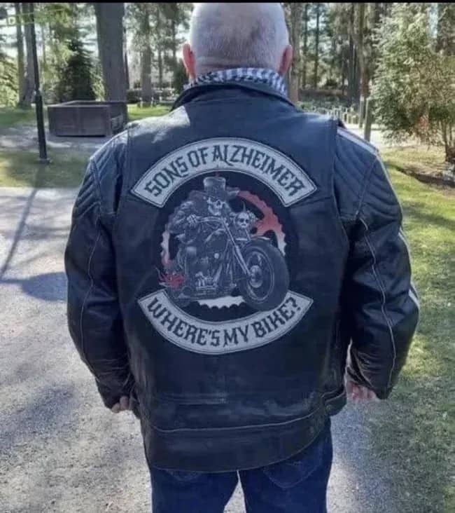 Biker wearing a funny Sons of Anarchy parody leather jacket reading Sons of Alzheimer.