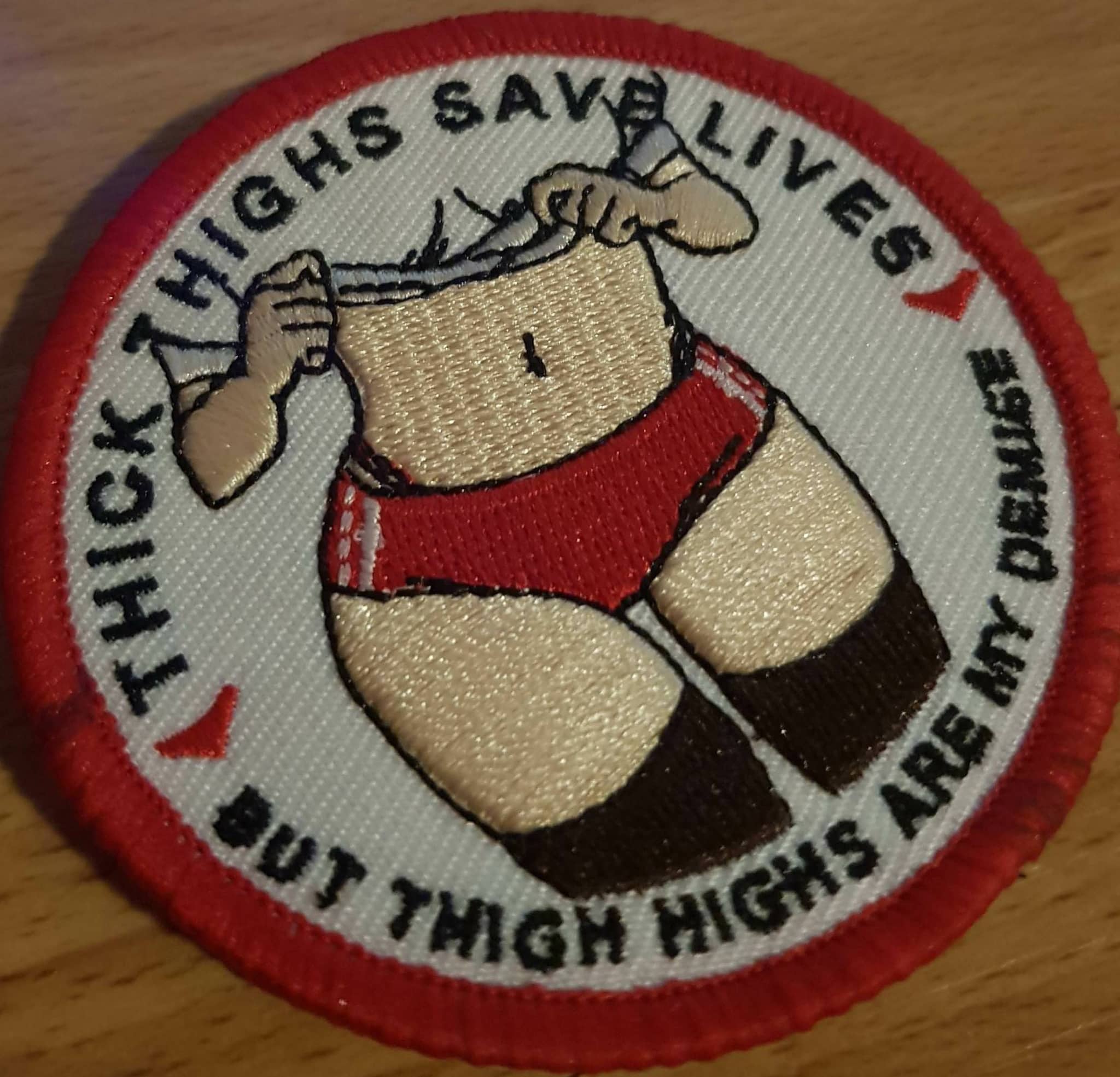 Funny embroidered patch meme featuring an anime style leg illustration with humorous text quote around it.