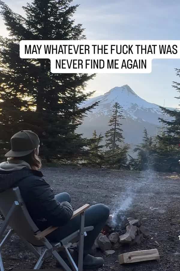 Person camping near mountains with funny memes text about avoiding terrifying experiences outdoors.