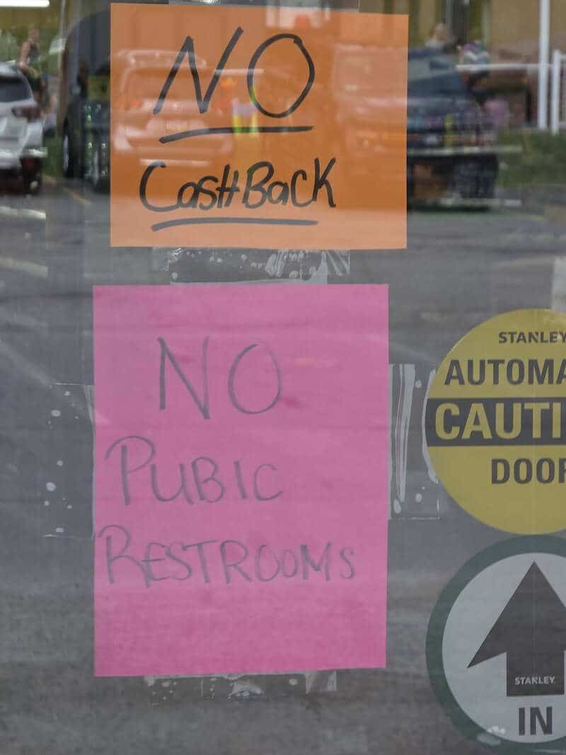 Storefront glass door with misspelled sign reading no pubic restrooms funny memes.
