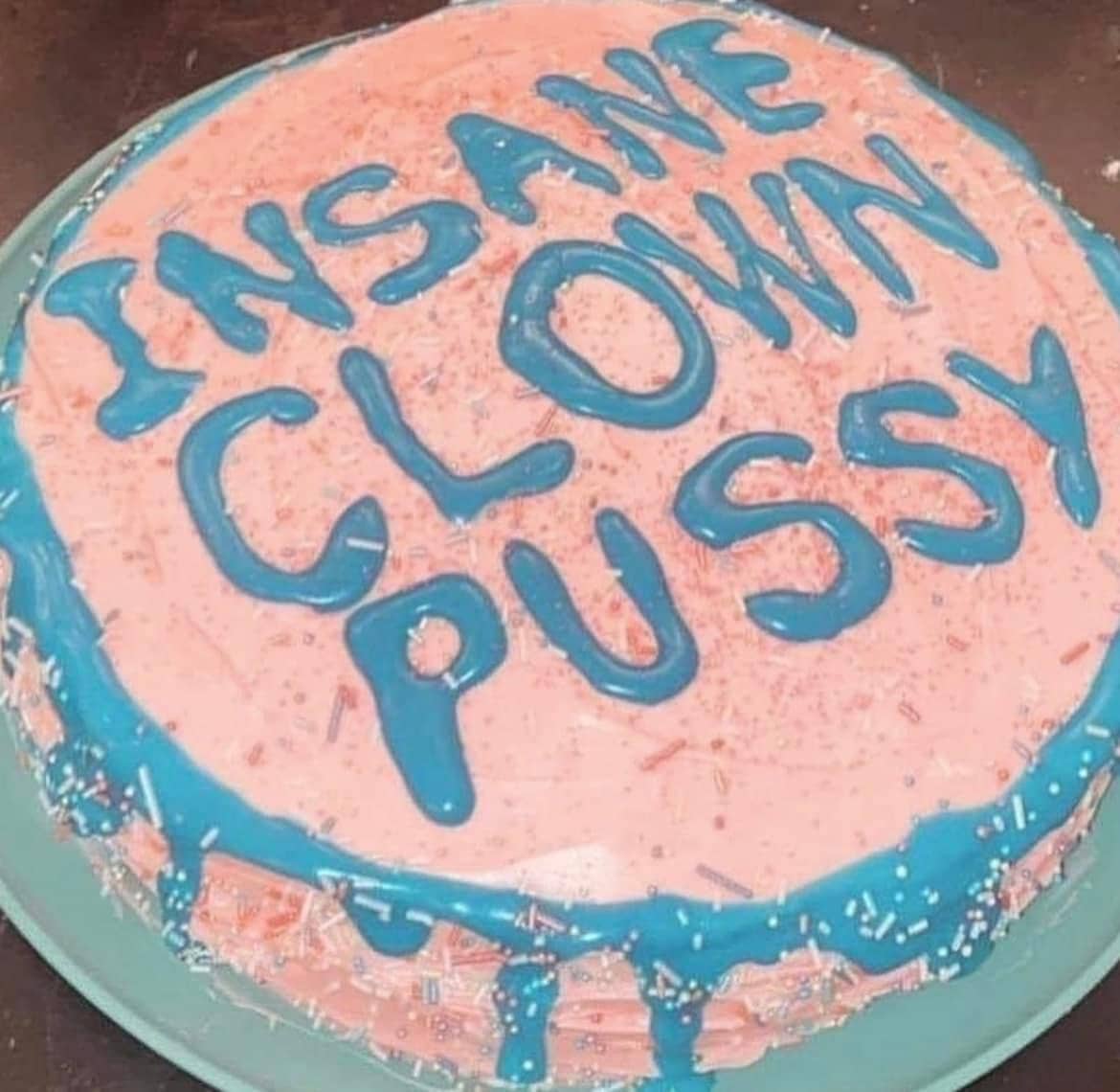 Round iced cake with blue frosting text spelling out a humorous phrase funny meme.