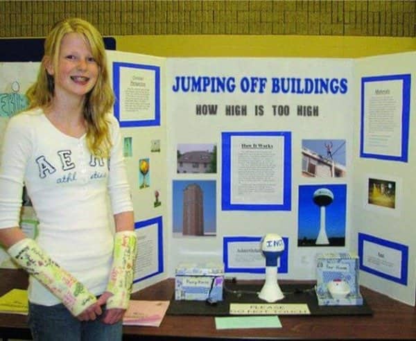 Girl with both arms in casts presenting project on jumping off buildings safely.