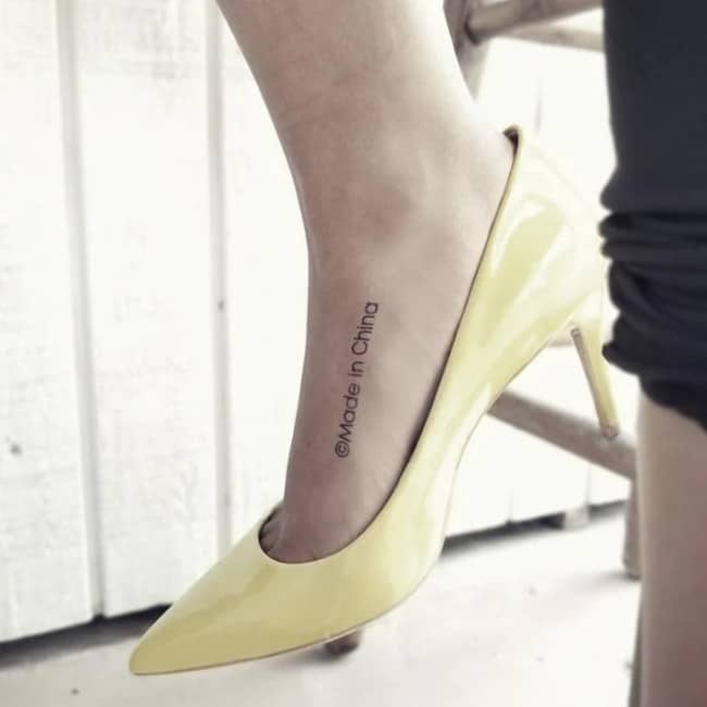 Woman wearing yellow heel with copyright made in China text featured in funny tattoos.