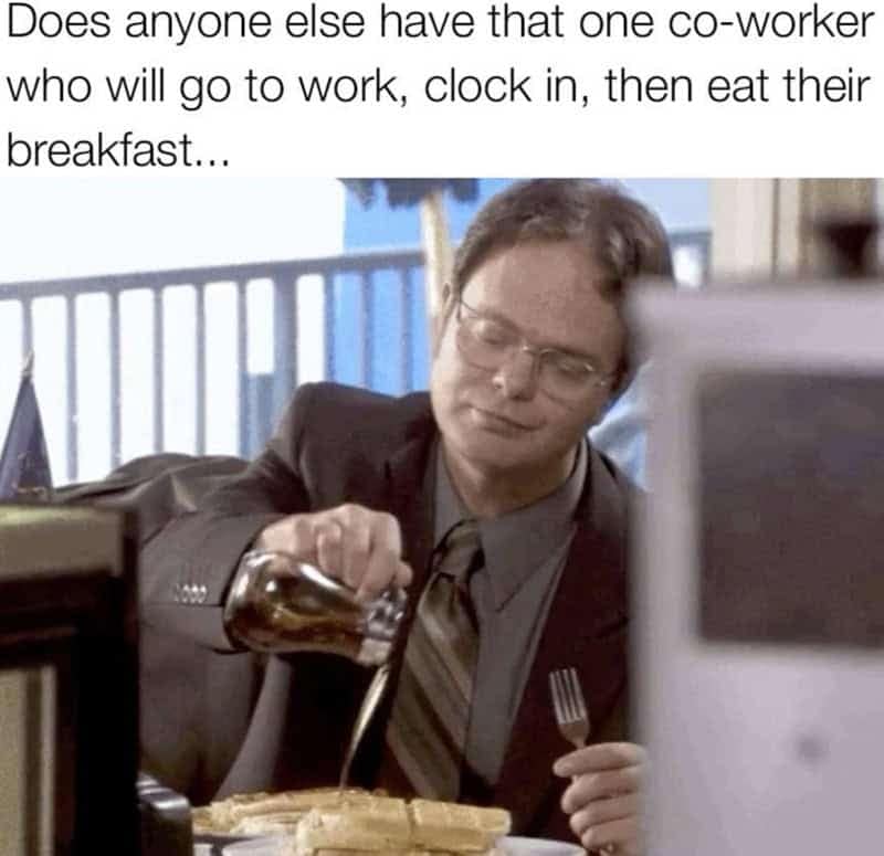 An office breakfast habit funny work meme showing Dwight Schrute pouring syrup on waffles at his desk immediately after clocking in.
