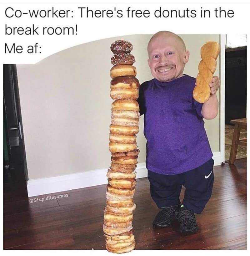 Free office food rush funny work meme showing Verne Troyer proudly standing next to a tower of glazed donuts stacked as tall as his head.