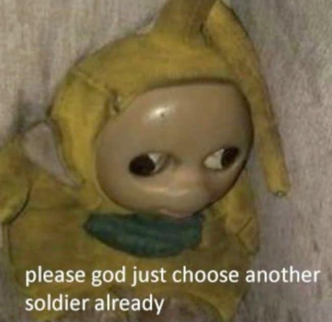 An exhausted burnout hangover meme featuring a battered yellow Teletubby toy slouched against a wall, captioned "please god just choose another soldier already."