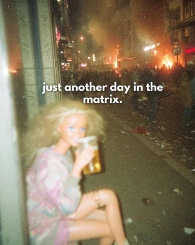 Nighttime chaos hangover meme depicting a Barbie doll sitting on a littered street drinking beer in front of fires, captioned "just another day in the matrix."
