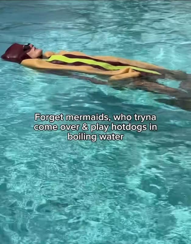 Someone floats peacefully on their back in a backyard swimming pool wearing a full-body hot dog suit, accompanied by caption text asking who wants to come play hot dogs in boiling water in this funny meme dump upload.