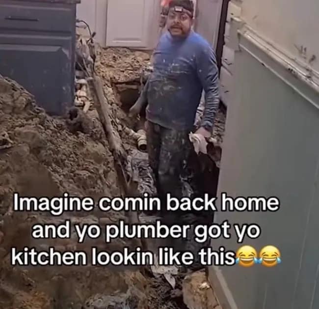 Plumber standing in a kitchen where the entire floor has been excavated into a massive dirt trench, featured in a meme dump.