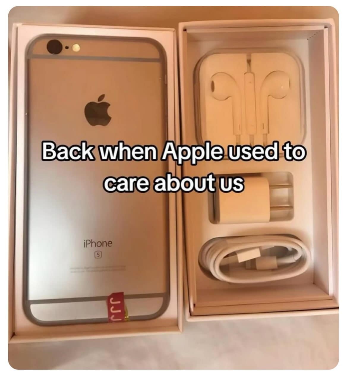 Nostalgic photo of an opened iPhone 6s box showing a full set of included factory accessories, including wired EarPods, a wall charging brick, and a Lightning cable.