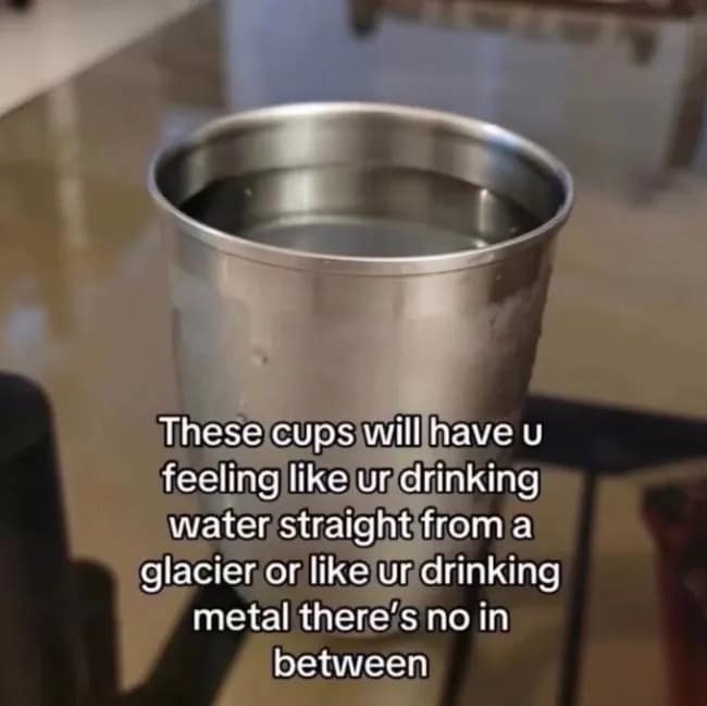 Stainless steel cup filled with cold water, captioned about the intense sensation of drinking either glacier water or pure liquid metal.