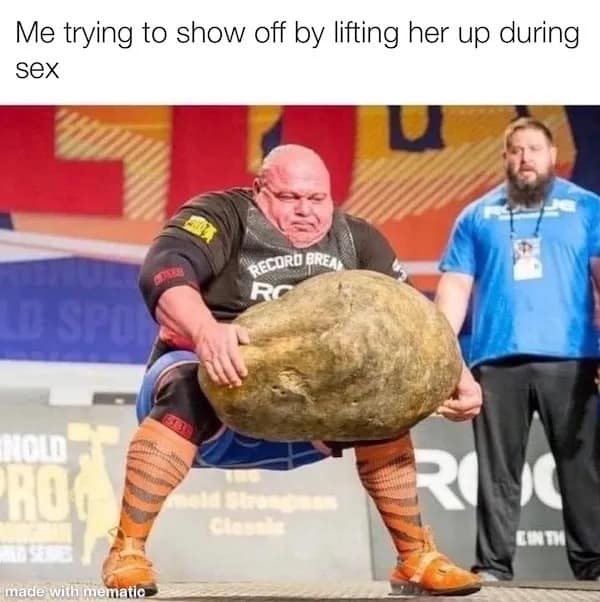 Strongman straining with intense facial expression while lifting a massive Atlas stone, capturing the physical struggle of attempting to lift a partner.
