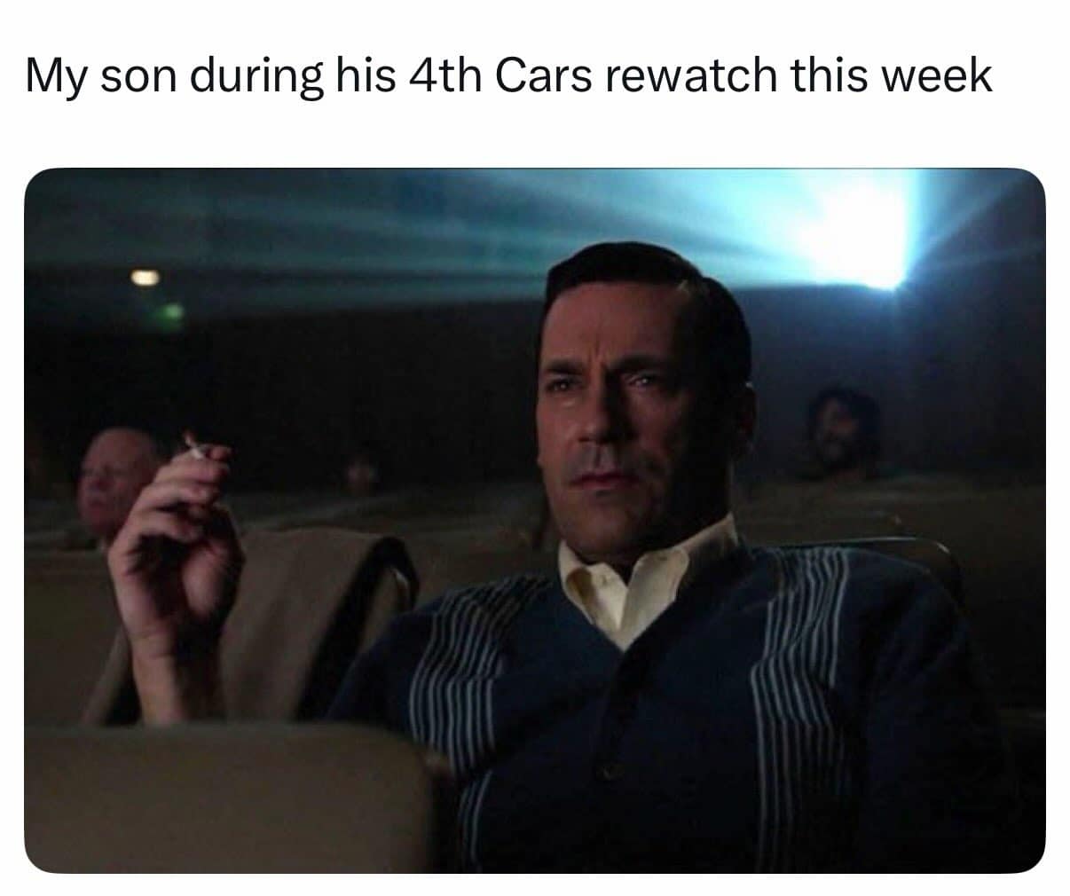 Jon Hamm as Don Draper from Mad Men sitting intently in a dark movie theater holding a cigarette under text about watching the movie Cars.