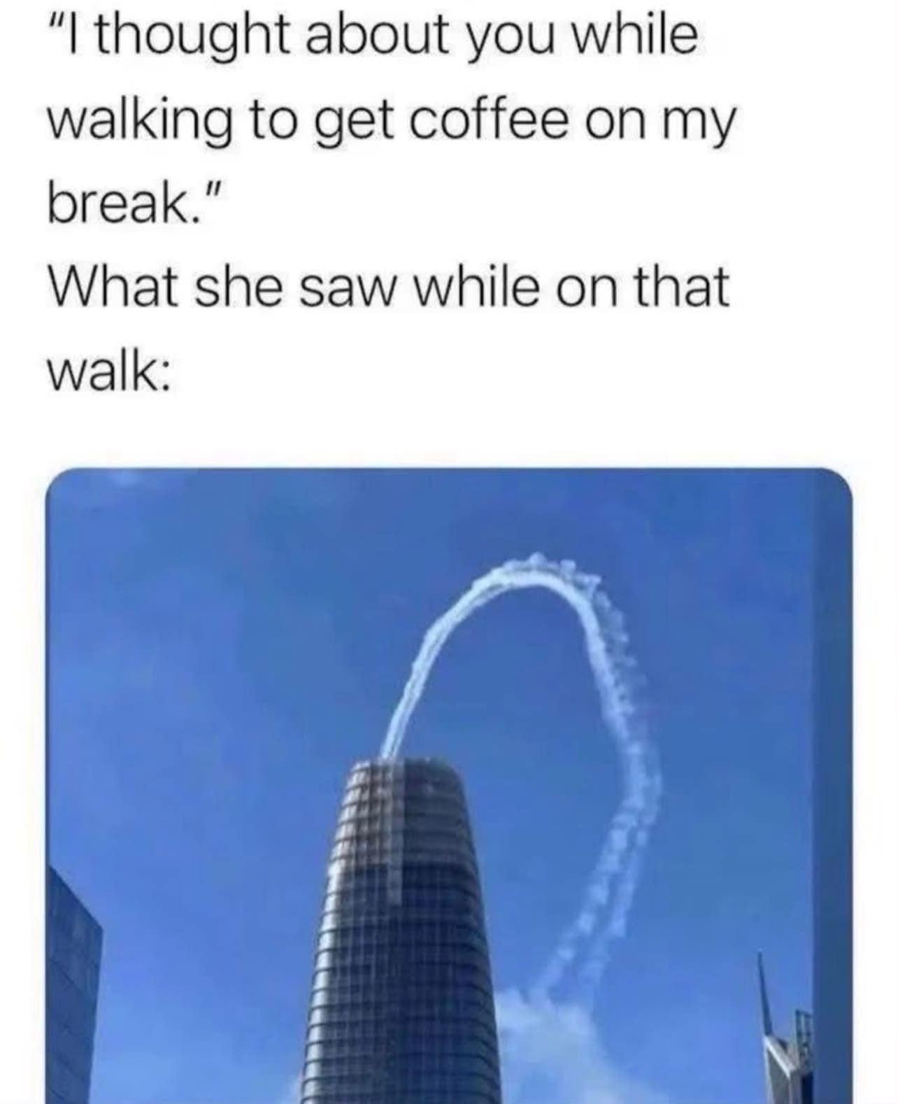 An accidental skywriting optical illusion photo operating as a funny meme showing plane vapor trails forming a massive arch behind a skyscraper.