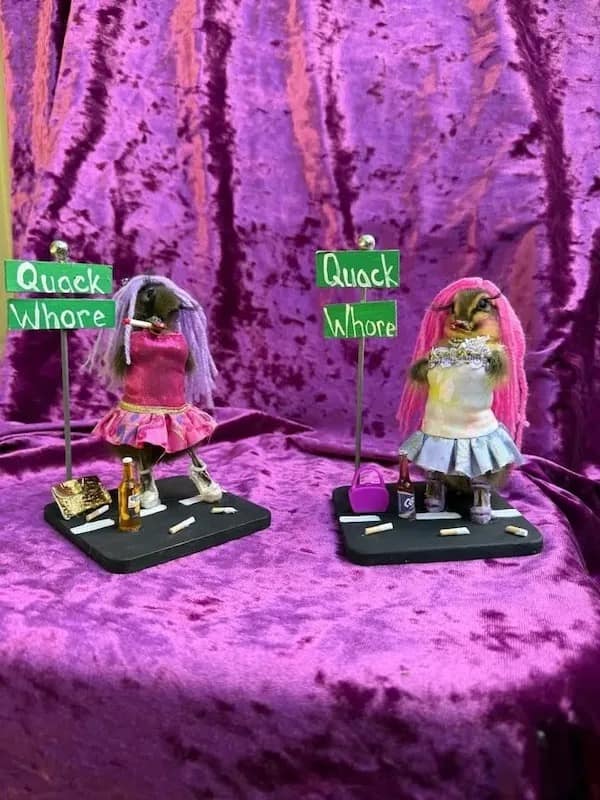 A bizarre taxidermy art display featured as a funny meme in this dump, showing stuffed chipmunks in tiny nightclub dresses and pink wigs standing next to "Quack Wh*re" signs.