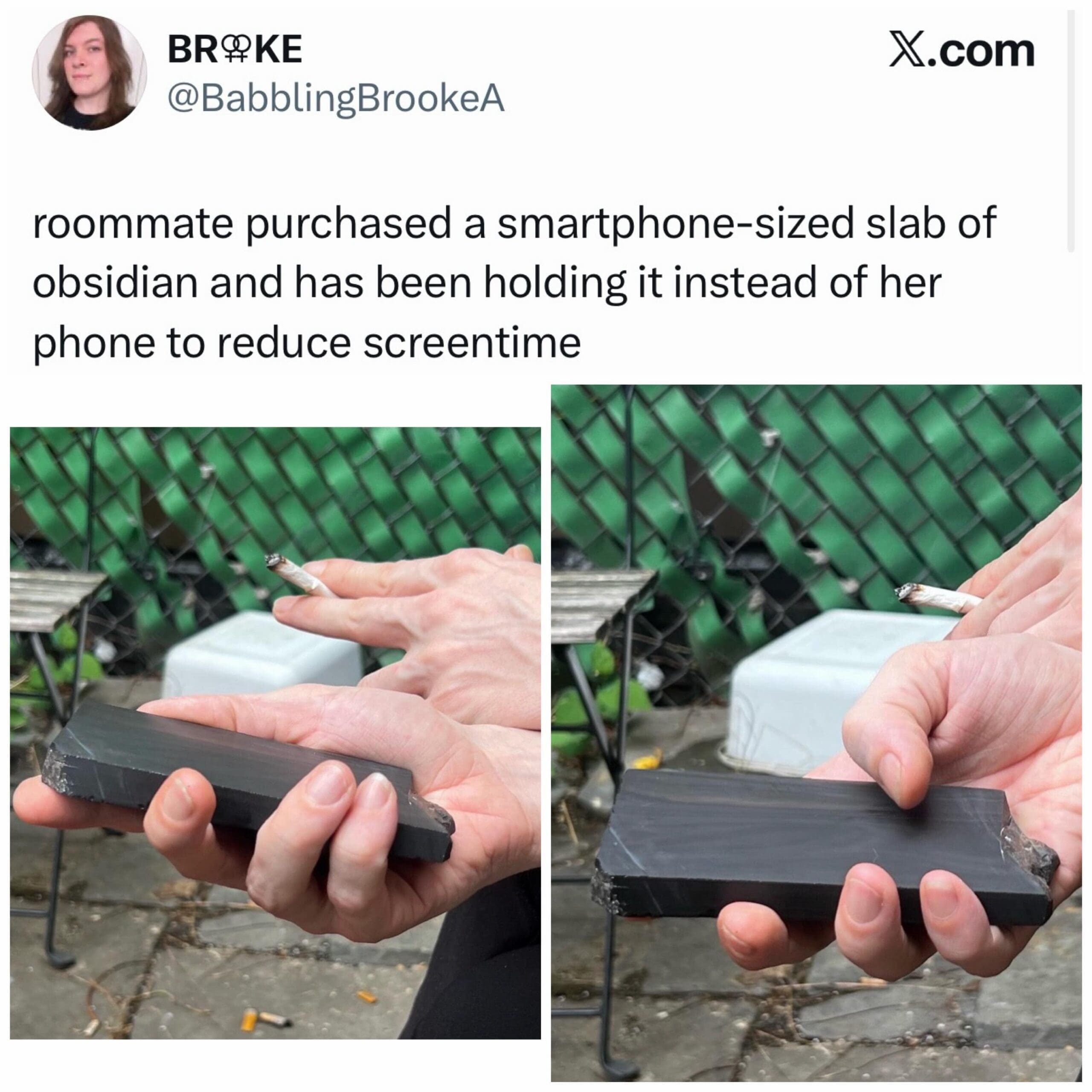 A person holding a smartphone-sized slab of polished black obsidian rock in their hand as a tactile replacement to lower screen time.